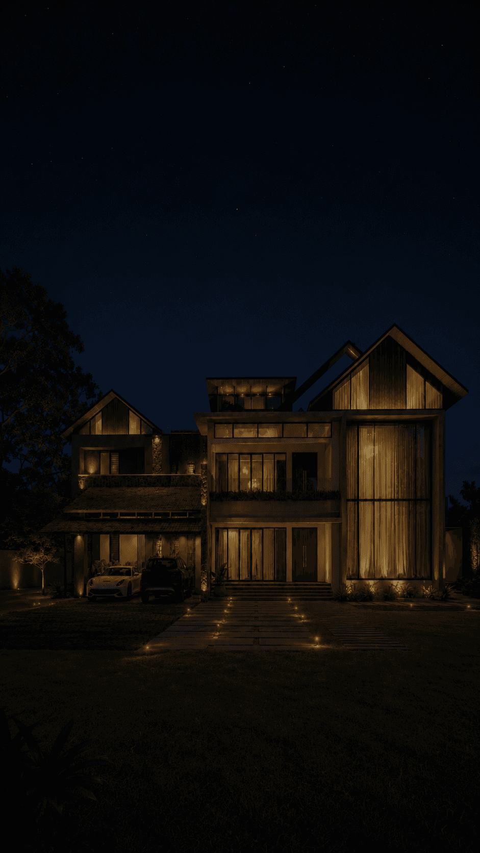A large residence at night, its gabled timber-clad volumes and full-height glazing lit from within