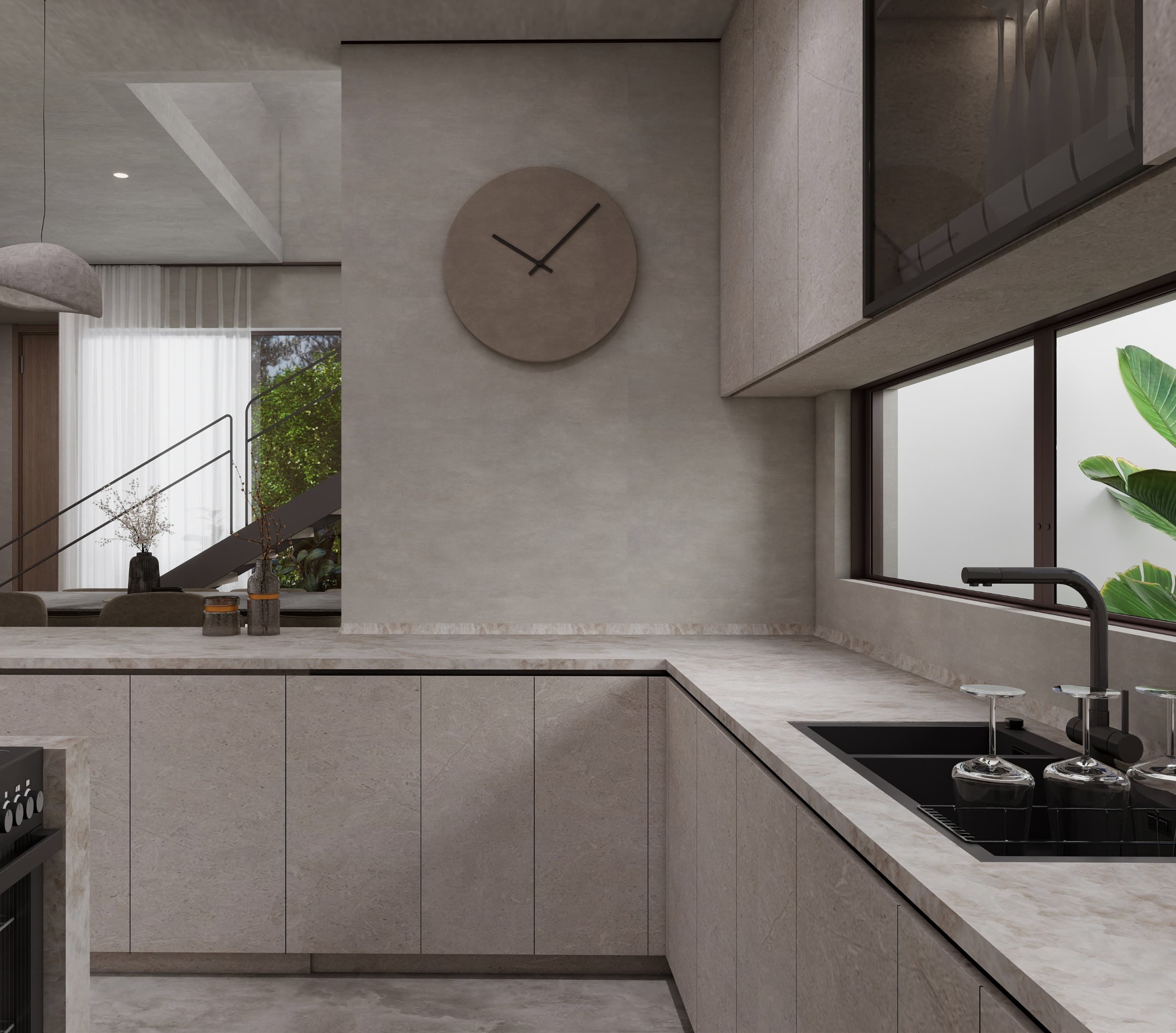 Kitchen counter in pale stone running to a window above the sink, with the dining hall and stair visible past the return
